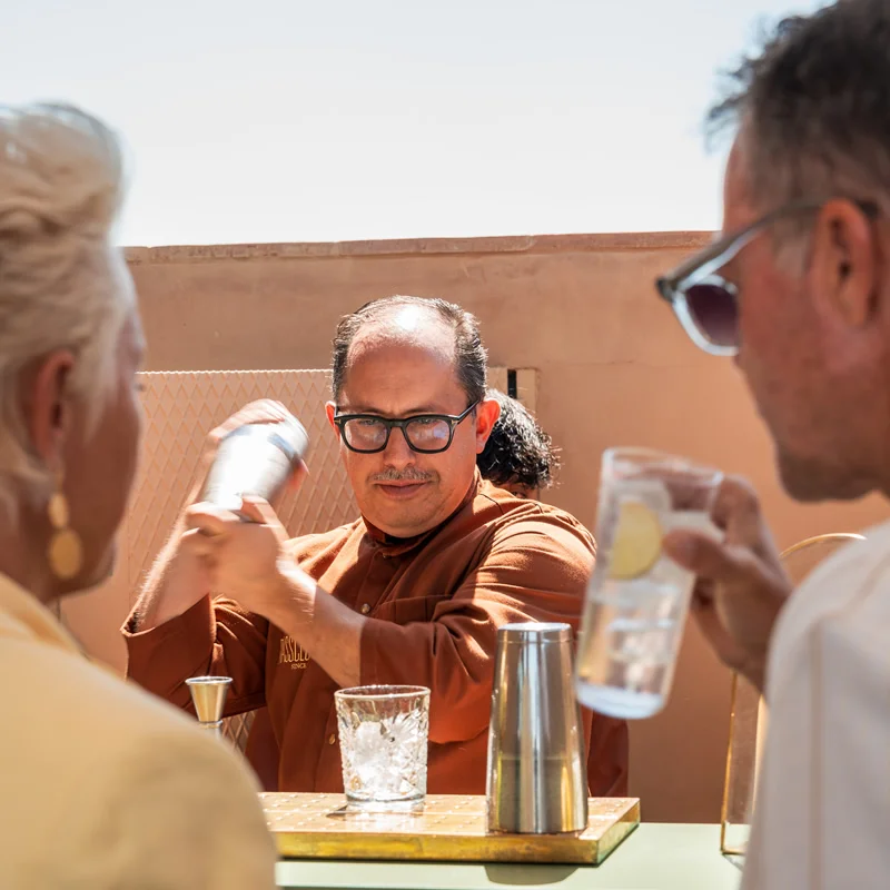 Coctelero preparando bebidas para los invitados durante un evento exclusivo de Pomellato en una terraza de Palma.